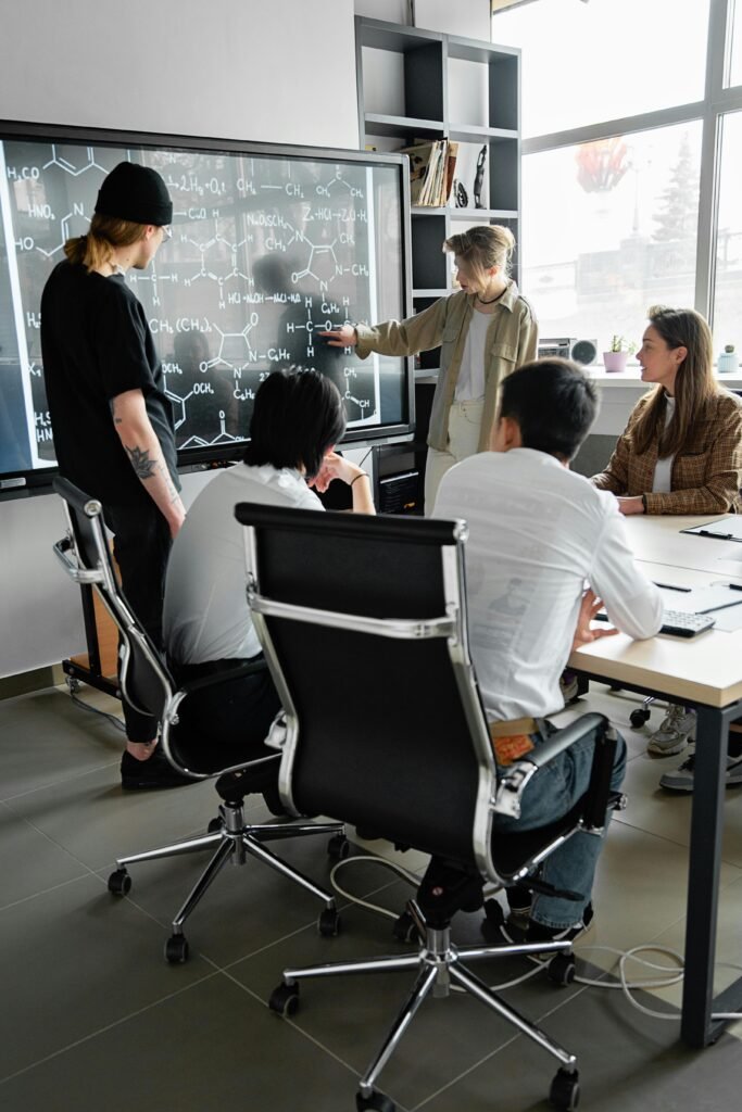 Group of professionals engaged in a collaborative meeting in a modern conference room.